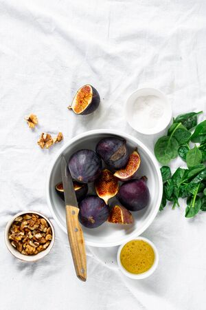 Ingredients for cooking vegetarian salad of figs, nuts and spinach top viewの写真素材