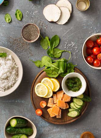Ingredients for preparation poke bowl with salmon, avocado, vegetables and chia seeds top viewの写真素材