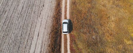 Aerial, Top Down view car driving down in rough terrainの写真素材