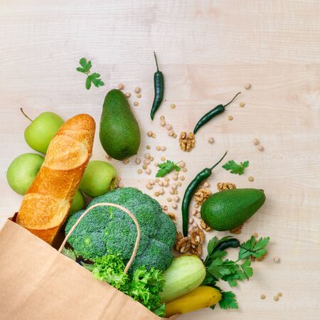 Shopping bag food with healthy food on a wooden background with copy space top viewの写真素材