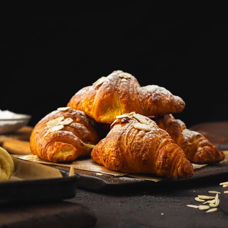 Breakfast croissant with chocolate on a dark stone backgroundの写真素材