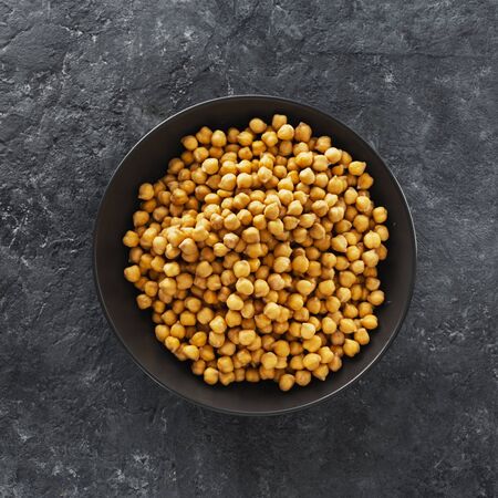 Cooking chickpeas in bowl on dark stone background top viewの写真素材