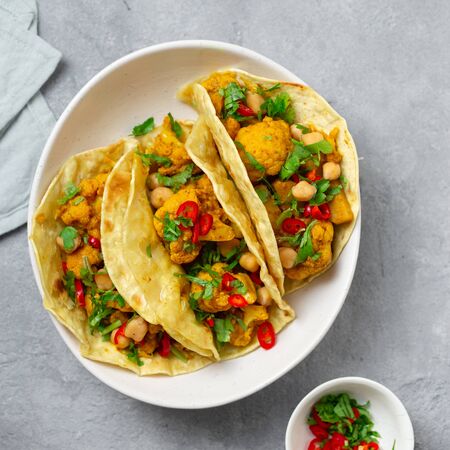 Tortilla with aloo gobi and chickpeas on concrete background top viewの写真素材
