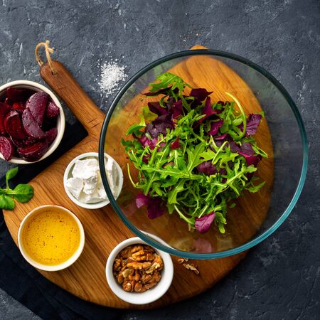 Ingredients for cooking diet summer healthy food top view. preparation salad with baked beets on dark background with copy spaceの写真素材