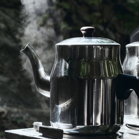 Camping camp holidays concept. Two teapots with hot teaの写真素材
