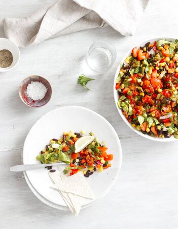 Mexican taco salad in plates on light wooden table top viewの写真素材