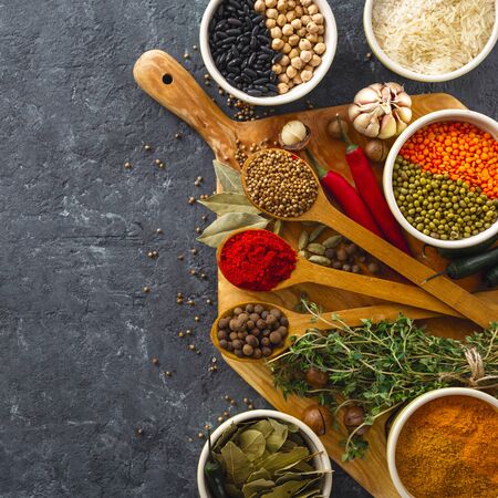 Spices, herbs, rice and various beans and seasonings for cooking on dark backgraund with copy space top viewの写真素材