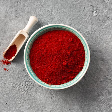Chili pepper powder on concrete background with free space for text top viewの写真素材