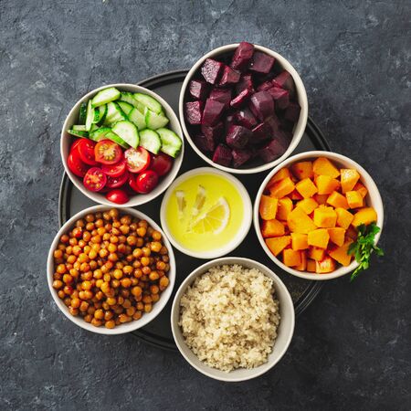 Healthy vegetarian ingredients for cooking moroccan salad. Chickpeas, Baked pumpkin and beets, quinoa and vegetables top view copy spaceの写真素材