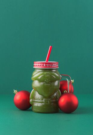 Zero waste concept. Green smoothie in glass santa claus jar. Healthy and diet food conceptの写真素材
