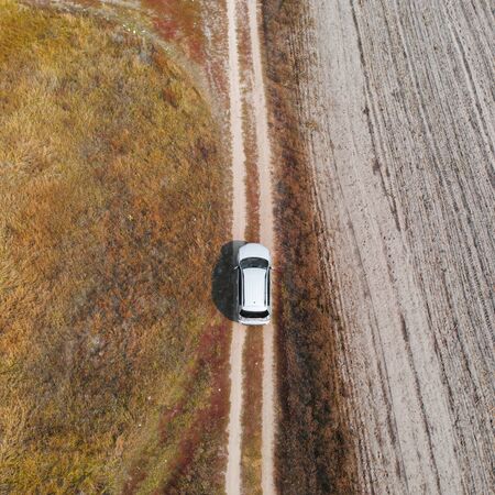 Aerial, Top Down view car driving down in rough terrainの写真素材