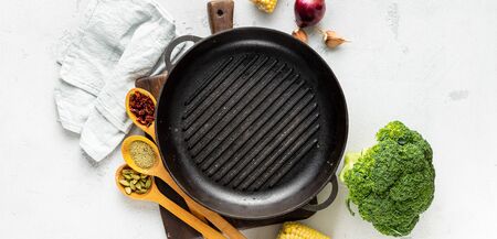 World vegan day concept. Empty grill pan with fresh vegetarian various ingredients for cooking vegan grilled food top viewの写真素材