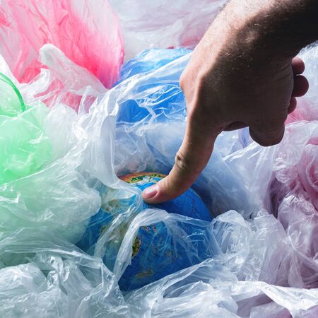 Human Impact on the Environment Pollution concept Earth in a plastics bags