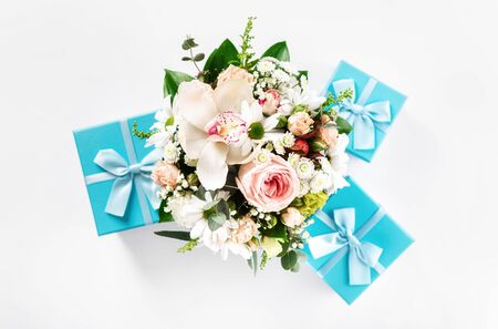 Top view flower bouquet on white background with gift boxes flat layの写真素材