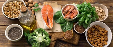 Health food fitness. Food sources of omega 3 and omega 6 on dark background top view. Foods high in fatty acids including vegetables, seafood, nut and seedsの写真素材
