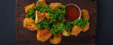 Vegan snack Buffalo wings made from roasted broccoli top view. Tasty vegetarian food top viewの写真素材