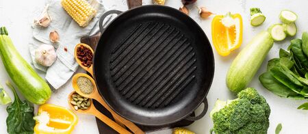 World vegan day concept. Empty grill pan with fresh vegetarian various ingredients for cooking vegan grilled food top viewの写真素材