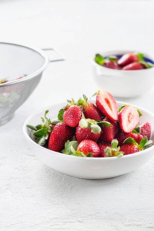 Bowl of fresh strawberries on white backgroundの写真素材