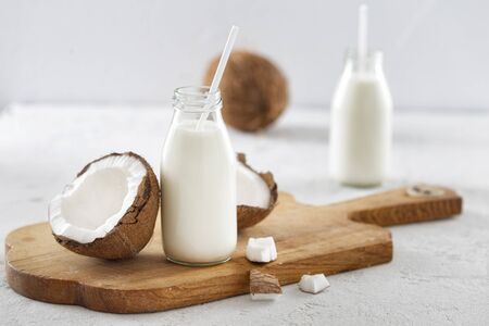 Coconut kefir in bottles on white background. Healthy eating concept. Fermented drinksの写真素材