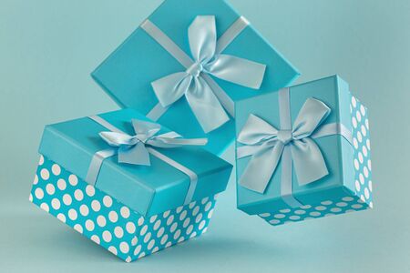 Collection of blue gift boxes with ribbons on blue background Copy spaceの写真素材