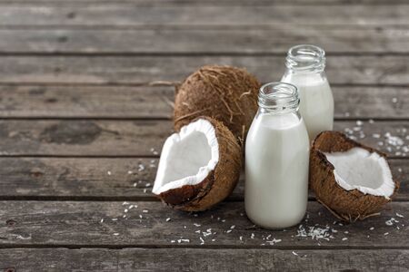 Coconut kefir in bottles on wooden table. Vegan non dairy healthy or fermented drink. Healthy eating conceptの写真素材