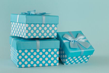 Collection of blue gift boxes with ribbons on blue background Copy spaceの写真素材