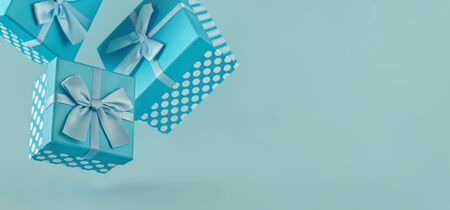 Collection of blue polka dot gift boxes with ribbons on blue background Copy spaceの写真素材