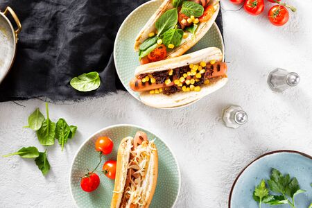 Dinner table with different homemade hot dogs top viewの写真素材