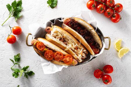 Three different hot dog grills served in a pan on a light background, top viewの写真素材