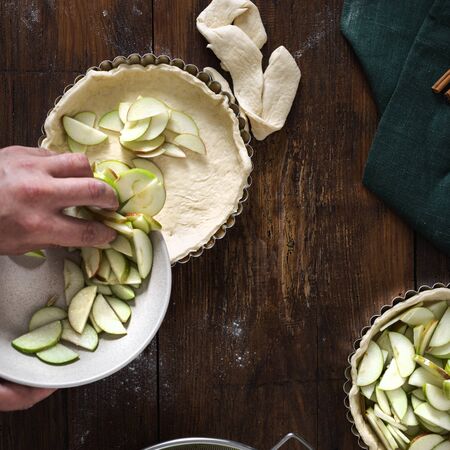 Man cooking homemade apple tart top viewの写真素材