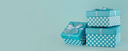 Collection of blue polka dot gift boxes with ribbons on blue background Copy spaceの写真素材