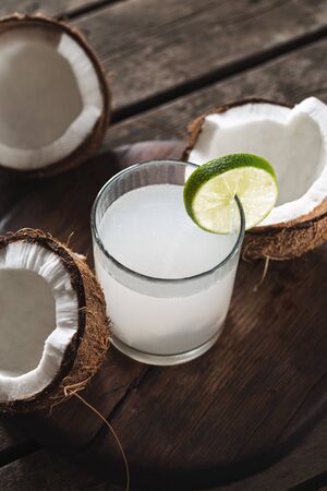 Coconut water in bottles on wooden table. Healthy drinks conceptの写真素材