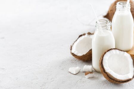Coconut kefir in bottles on light background. Vegan non dairy healthy or fermented drink. Healthy eating conceptの写真素材