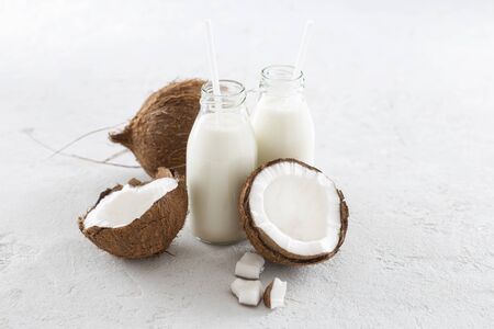 Coconut kefir in glass bottle on light background. Vegan non dairy healthy or fermented drink. Healthy eating conceptの写真素材