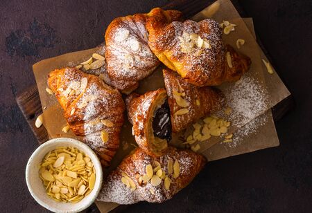 Breakfast croissant with chocolate on a dark stoneの写真素材