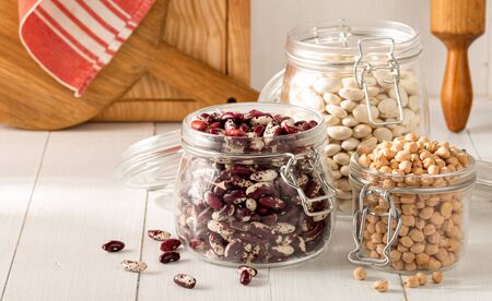 Raw grain bean in a glass jar in home kitchen. Source of protein for vegetarianの写真素材