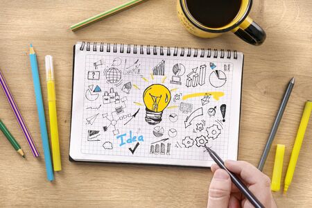 Man draws new business strategy in notebook. Startup strategy development concept top viewの写真素材