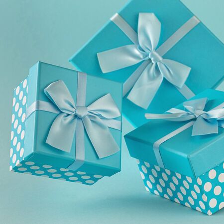 Collection of blue gift boxes with ribbons on blue background Copy spaceの写真素材
