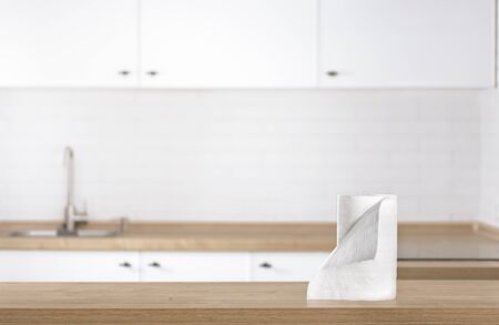 Paper kitchen towels on the kitchen table top on blur kitchen backgroundの写真素材