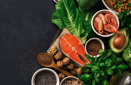 Food sources of omega 3 on dark background with copy space top view. Foods high in fatty acids including vegetables, seafood, nut and seeds. Health food fitnessの写真素材