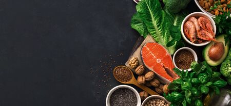 Food sources of omega 3 on dark background with copy space top view. Foods high in fatty acids including vegetables, seafood, nut and seeds. Health food fitnessの写真素材