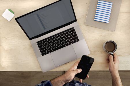 Freelancer businessman working laptop in home office top view. Remote work conceptの写真素材