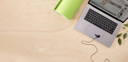 Online sports or yoga training concept Laptop with yoga mat  and microphone on the table top viewの写真素材