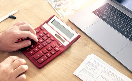 Tax payment concept. Business man using calculator for calculating taxesの写真素材