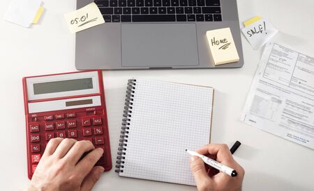Man writes tax payment plan at homeの写真素材