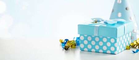Celebration background with gift box, colorful party streamers, confetti and birthday party hatsの写真素材