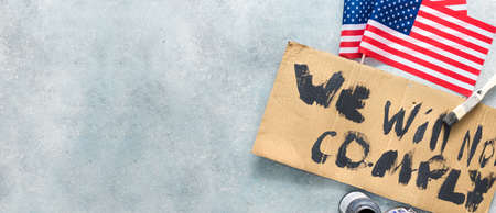 Protests concept. Phrase we will not comply written on cardboard overhead viewの写真素材