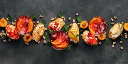 Summer drink with various fruit bruschetta on dark background top view. Delicious appetizersの写真素材