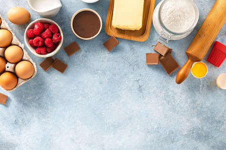 Ingredients for cooking raspberries and chocolate pie with copy space top view. Bakery backgroundの写真素材
