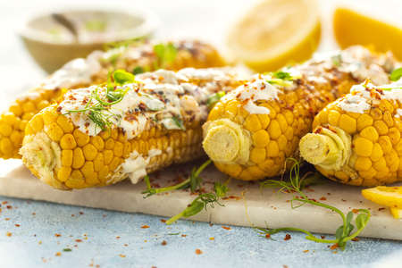 Vegan dinner with grilled sweet cob corn. Summer vegetarian snacksの写真素材